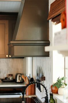 a stove top oven sitting inside of a kitchen next to a sink and countertop