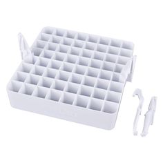 an image of a white tray with toothbrushes and combs in it on a white background