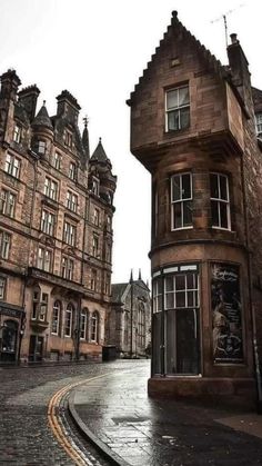 an old building on the corner of a cobblestone street in edinburgh, scotland