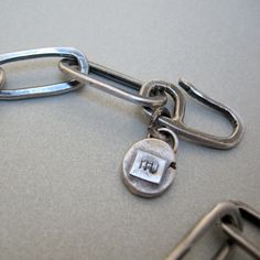 "Men's bracelet, in sterling silver, consisting of long, rectangular, and hammered links. Made with 12 gauge wire, it offers beauty and durability over time. Length 8,07\" Weight 0,68 Oz. Like all my pieces of jewelry, it is made by hand and one at a time. This type of processing produces objects that are always slightly different from each other, and this is the added value to each of my pieces. Thank you for visiting my shop, I hope you have found something you like to gift or for yourself! If Sterling Silver Bracelet With Rectangular Links And Polished Finish, Sterling Silver Bracelet With Polished Rectangular Links, Sterling Silver Bracelets With Rectangular Links Box Chain, Sterling Silver Chain Bracelet With Rectangular Links, Silver Bracelets With Rectangular Links And Sterling Clasp, Sterling Silver Bracelets With Oxidized Finish And Chain Link, Sterling Silver Oxidized Link Chain Bracelet, Modern Sterling Silver Bracelet With Solid Link, Modern Oxidized Link Chain Bracelet