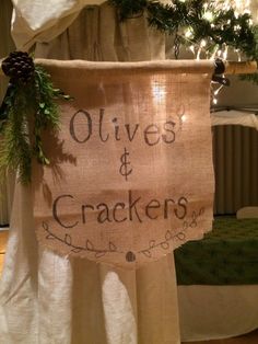 a sign that says olives and crackers hanging from the side of a bed