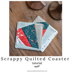 two quilted coasters sitting on top of a wooden table with the words scrappy quilt