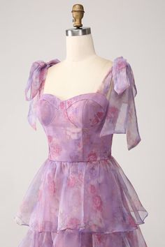 a purple dress on a mannequin dummy with pink flowers and ruffles