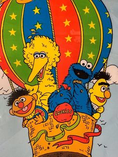 the sesame street characters are riding in a hot air balloon