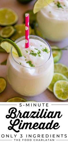 a close up of a drink on a table with limes