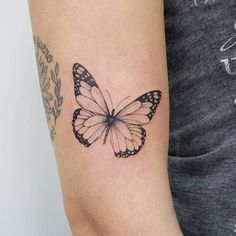 a small butterfly tattoo on the right arm and left arm, it is black and white