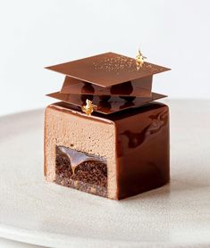 there is a chocolate cake with a graduation cap on it's top in the shape of a square