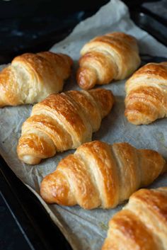 freshly baked croissants are sitting on a baking sheet