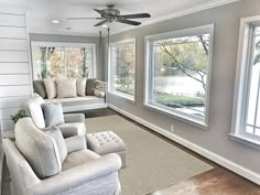 a living room filled with furniture and windows