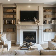 a living room filled with furniture and a flat screen tv mounted above a fire place