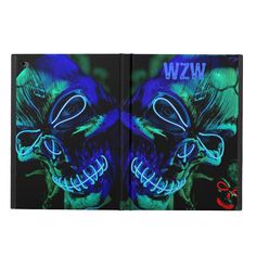 an open book with blue and green lights on the pages, depicting two skulls in neon colors