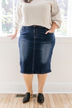 Trends come and go but denim remains a wardrobe staple! Crafted from a comfortable stretch denim in a timeless dark blue wash, the Wren will be your new go to skirt! The details include a traditional button and fly closure and functional pockets. And the very best part - this modest denim skirt comes in three lengths for you to choose from! Exclusively designed by us for you. 95% Cotton 5% Spandex Wash Cold Gentle Cycle Hang to Dry Low Iron if Needed Model A Height 5'5" | Wearing Size 2 - 23" Le Medium Wash Denim Skirt For Fall, Fall Medium Wash Denim Skirt, Dark Wash Mid-rise Denim Skirt, Mid-rise Dark Wash Denim Skirt, Dark Wash Stretch Denim Mid-rise Skirt, Mid-rise Stretch Dark Wash Denim Skirt, Stretch Mid-rise Dark Wash Denim Skirt, Modest Denim Skirts, Blue Jean Skirt