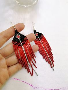 Handmade Red Beaded Long Drop Earrings, Handmade Red Long Drop Beaded Earrings, Red Beaded Dangle Earrings With Tassels, Red Beaded Fringe Tassel Earrings Gift, Red Tassel Earrings With Fringe And Round Beads, Traditional Red Jewelry With Fringe, Red Fringe Tassel Earrings With Round Beads, Handmade Red Tassel Earrings With Round Beads, Elegant Red Beaded Earrings With Fringe