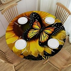 the table is set with two white plates and three cups, one has a butterfly on it