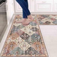 a woman standing on top of a rug in a kitchen