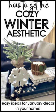 a christmas tree sitting on top of a table next to a tray with cookies and an ornament