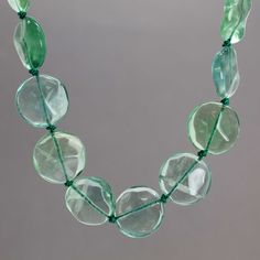 A gorgeous strand of hand knotted Fluorite gemstones! This is an endless strand 32" long, knotted using green silk thread. It makes a statement!100% Natural AAA Green Fluorite Gemstone BeadsBeads are about 20 mm DiameterNecklace is 32" Long, no clasp~ Slides easily over headGreen Silk ThreadArtisan Made in Texas, USAThoughtfully packaged in a signature kraft jewelry box ready to gift Green Crystal Necklaces With Round Hand-strung Beads, Artisan Green Crystal Necklaces With Gemstone Beads, Green Hand-strung Long Necklace, Adjustable Single Strand Green Crystal Necklace, Green Single Strand Long Beaded Necklace, Green Long Single Strand Beaded Necklace, Green Hand-strung Crystal Necklaces For Healing, Green Hand-strung Crystal Necklace For Healing, Green Healing Crystal Necklace Hand-strung