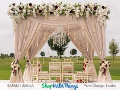 an outdoor wedding set up with flowers and chairs