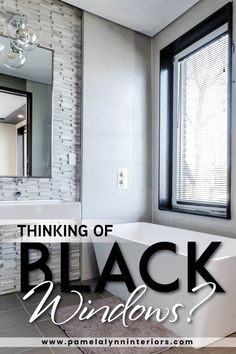 a white bath tub sitting next to a window with the words thinking of black windows