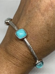 Huge natural Blue Turquoise with quartz over lay gemstone set in a design Wrap around bangle 8 inch interior wrist. All hand made 925 Sterling Silver All jewelry is shipped in a nice gift box. Check out our over a THOUSAND great reviews Engraving is $4 per letter and is not always perfect depending on the piece. It can take a few days if the jeweler is busy. This is payable to Paypal Judithsltd@gmail.com Elegant Adjustable Turquoise Sterling Silver Bracelet, Elegant Turquoise Gemstone Sterling Silver Bracelet, Elegant Turquoise Bangle For Gift, Elegant Turquoise Cuff Bracelet With Natural Stones, Peacock Pearls, Vintage Turquoise, Genuine Turquoise, Silver Bracelets, Turquoise Bracelet