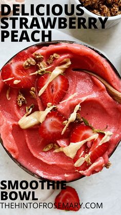 a bowl filled with strawberries and granola on top of a table