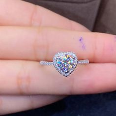 ❤ Moissanite Ring Information❀ Moissanite Size and Weight: 6.5 mm, 1 ct. ❀ Moissanite Clarity: VVS1.❀ Moissanite Shape: Brilliant Round Cut.❀ Moissanite Color: D Colorless.❀ Moissanite Make: Great Quality.❀ Moissanite Ring Setting: Prongs Setting.❀ Accent stone: dainty cubic zirconia ( cz diamond).❀ Metal Materials: 925 sterling silver, 18K gold plated.❀ Metal color: Silver, yellow gold color ❤ Customize Making RingRing size from US #3 to US #16.Accept customize in solid 9K / 14K / 18K yellow go Moissanite Heart Cut Diamond Ring For Proposal, Heart Cut Moissanite Diamond Ring For Proposal, Moissanite Heart Ring For Wedding With Round Cut, Diamond White Moissanite Halo Ring For Promise, Moissanite Heart Ring For Promise, Moissanite Heart Ring With Prong Setting As Gift, Moissanite Heart Ring With Round Cut For Gifting, Moissanite Heart Ring With Center Stone For Promise, Moissanite Heart Promise Ring