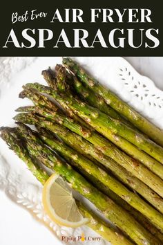 asparagus on a white plate with lemon wedges and text overlay that reads perfect air fryer asparagus