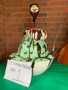 an ice cream bowl is decorated with chocolate and green icing