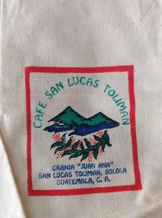 the san lucas township logo is shown on a white t - shirt with red trim