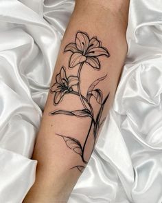 a black and white flower tattoo on the leg