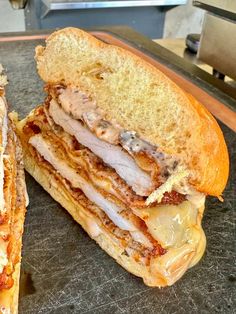 a cut in half sandwich sitting on top of a cutting board