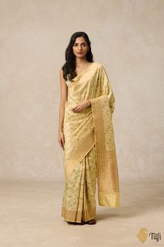 Delicate yet unforgettable, this saree brings to life the purity of Jasmine. Adorned with silken jaals of white flowers, this silk saree evokes the fragrant warmth of a nostalgic evening breeze—a quiet homage to moments of serenity. Serenity Color, Pastel Yellow, Silk Saree, White Flowers, Saree