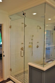 a walk in shower sitting inside of a bathroom