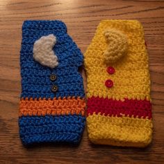 two crocheted cell phones sitting on top of a wooden table next to each other