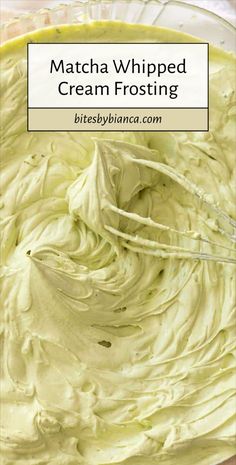 a bowl filled with cream frosting on top of a wooden table