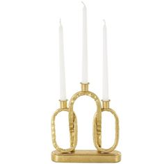 three candles are sitting on a stand with two white candles in the shape of horseshoes