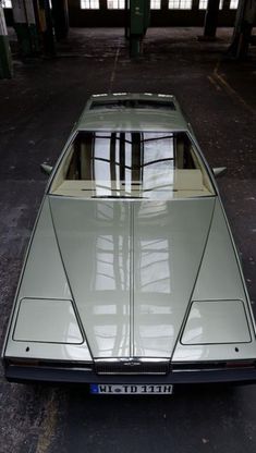 an old car is parked in a garage