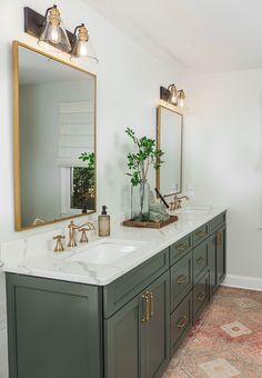 a bathroom with two sinks and mirrors in it