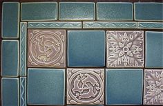 some blue and white tiles with designs on them