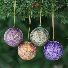 three ornaments hanging from a christmas tree