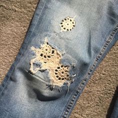 an old pair of jeans with holes in them