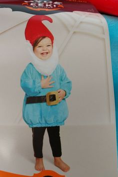 a child wearing a santa hat and blue outfit