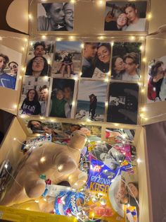 an open box with pictures and lights on the inside is filled with people's photos