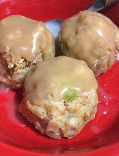 three doughnuts with icing sitting on a red plate