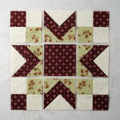 the block is made up of four different blocks, each with red and white flowers on them