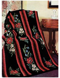 a black and red blanket with flowers on it