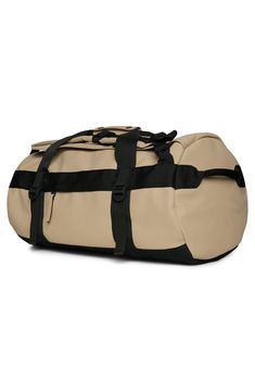 the duffel bag is beige and black with straps on it's sides, which are