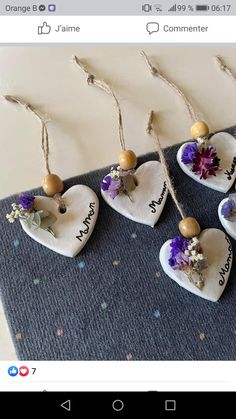 four small hearts with flowers hanging from them