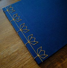 a blue book with gold thread work on it