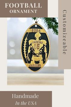 a football ornament hanging from a christmas tree with the words handmade in the usa